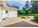 Exterior patio and entry to the home surrounded by lush landscaping, adding a touch of natural beauty at 1550 Masters Club Dr, Sandy Springs, GA 30350