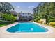 Large swimming pool with surrounding patio offers a relaxing outdoor space with a spacious backyard at 1550 Masters Club Dr, Sandy Springs, GA 30350