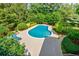 Aerial view of a private in-ground pool surrounded by lush landscaping creating a backyard retreat at 1550 Masters Club Dr, Sandy Springs, GA 30350