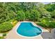 Inviting in-ground pool surrounded by lush landscaping, perfect for outdoor relaxation and entertainment at 1550 Masters Club Dr, Sandy Springs, GA 30350