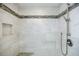 Close up on tiled shower with multiple shower heads, a built-in bench, and tiled niche at 1550 Masters Club Dr, Sandy Springs, GA 30350