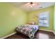 Cozy bedroom with hardwood floors, a floral patterned bedspread and natural light at 1963 Lakeshore Overlook Nw Cir, Kennesaw, GA 30152