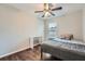 Bedroom features wood-look floors, ceiling fan, window, and desk space at 1963 Lakeshore Overlook Nw Cir, Kennesaw, GA 30152