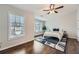 Bright primary bedroom featuring hardwood floors, natural light, and a modern ceiling fan at 1963 Lakeshore Overlook Nw Cir, Kennesaw, GA 30152