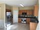 Well-lit kitchen featuring stainless steel appliances, tile flooring, and wooden cabinetry at 1963 Lakeshore Overlook Nw Cir, Kennesaw, GA 30152