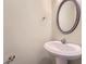 Cozy powder room with a pedestal sink, decorative mirror, and classic fixtures at 1963 Lakeshore Overlook Nw Cir, Kennesaw, GA 30152