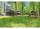 Spacious backyard featuring a wooden swing set and tree surround property at 2871 Liberty Ct, Marietta, GA 30066