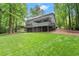 Large backyard with lush green grass and view of deck, patio and screened-in porch at 2871 Liberty Ct, Marietta, GA 30066