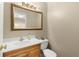 Cozy powder room with golden framed mirror, faucet, and a wooden cabinet at 2871 Liberty Ct, Marietta, GA 30066