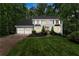 Classic two-story home with an American flag, bay windows, black shutters, and a well-manicured lawn at 2871 Liberty Ct, Marietta, GA 30066