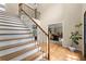 Welcoming foyer with wood staircase, iron railing, and hardwood floors leading to a bright home office at 2871 Liberty Ct, Marietta, GA 30066