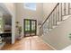 Inviting foyer featuring a grand staircase, hardwood floors, and a glass-paneled front door at 2871 Liberty Ct, Marietta, GA 30066