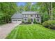 Landscaped front yard leading up to a two-story gray brick home with a two car garage at 2871 Liberty Ct, Marietta, GA 30066