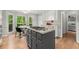 Spacious kitchen featuring an island with cooktop and a cozy breakfast area overlooking nature at 2871 Liberty Ct, Marietta, GA 30066