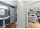 Cozy powder room with hardwood floors, pedestal sink, and adjacent access to the living room at 2871 Liberty Ct, Marietta, GA 30066