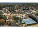 Aerial view of a neighborhood with single-Gathering homes, tree-lined streets, tennis courts and a community pool surrounded by trees at 510 Rosedown Way, Alpharetta, GA 30022