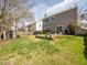 Backyard has a spacious lawn, patio seating, tasteful garden beds, and is enclosed by a wooden fence for privacy at 510 Rosedown Way, Alpharetta, GA 30022