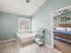 Bright bathroom features a soaking tub beneath a window, alongside a storage rack and open doorway to the main bedroom at 510 Rosedown Way, Alpharetta, GA 30022