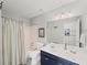 Bathroom features a double vanity, shower-tub combo with striped curtain, and tiled floor at 510 Rosedown Way, Alpharetta, GA 30022