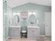 Bright bathroom with double vanity, decorative mirrors, sconce lighting, and tile floor at 510 Rosedown Way, Alpharetta, GA 30022