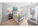 Cozy bedroom with a metal bed frame, bedside tables with lamps, and natural lighting at 510 Rosedown Way, Alpharetta, GA 30022