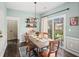Charming dining room with modern light fixture and sliding glass doors to the backyard at 510 Rosedown Way, Alpharetta, GA 30022