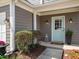 Close-up view of the home's inviting front entrance with a light blue front door and elegant outdoor lighting at 510 Rosedown Way, Alpharetta, GA 30022