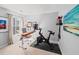 Home office features a desk, office chair, Peloton bike, and natural lighting at 510 Rosedown Way, Alpharetta, GA 30022
