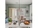 Bright eat-in kitchen features stainless steel faucet, pendant light, and sliding doors at 510 Rosedown Way, Alpharetta, GA 30022