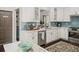 Well-equipped kitchen featuring stainless steel appliances, white cabinetry, and quartz countertops at 510 Rosedown Way, Alpharetta, GA 30022