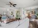 Open living area with hardwood floors, a ceiling fan, and a view into the dining area at 510 Rosedown Way, Alpharetta, GA 30022