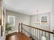 Open staircase foyer with hardwood flooring, iron railing, and natural light at 510 Rosedown Way, Alpharetta, GA 30022