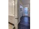 Bright bathroom and laundry area with vinyl floors and white cabinets at 6 Holly Downs Nw Ct, Atlanta, GA 30318