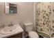Small bathroom featuring floral-themed shower curtain and small vanity at 6 Holly Downs Nw Ct, Atlanta, GA 30318