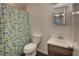 Small bathroom featuring a floral shower curtain, white toilet, and wood vanity at 6 Holly Downs Nw Ct, Atlanta, GA 30318