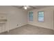Bright bedroom featuring neutral carpet, two windows offering natural light, and ceiling fan at 6 Holly Downs Nw Ct, Atlanta, GA 30318