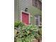 Charming home with a bright pink door and manicured greenery enhancing curb appeal at 6 Holly Downs Nw Ct, Atlanta, GA 30318