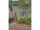 Charming two-story home with a bright pink door and well-maintained landscaping at 6 Holly Downs Nw Ct, Atlanta, GA 30318