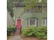 Charming two-story home with a bright pink door and well-maintained landscaping at 6 Holly Downs Nw Ct, Atlanta, GA 30318