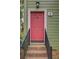 Charming home entrance featuring brick steps and a vibrant pink front door at 6 Holly Downs Nw Ct, Atlanta, GA 30318