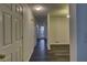 Hallway with hardwood floors leading to various rooms, offering a seamless flow at 6 Holly Downs Nw Ct, Atlanta, GA 30318