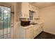 Well-lit kitchen with white cabinets, a double sink, and access to the deck at 6 Holly Downs Nw Ct, Atlanta, GA 30318