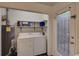Convenient laundry room with washer, dryer, and shelving at 6 Holly Downs Nw Ct, Atlanta, GA 30318