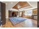 Spacious basement featuring wooden flooring, barn doors, stone accent wall, and a cozy window nook at 6640 Stratford Pl, Cumming, GA 30040