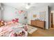 Charming bedroom featuring a white metal bed frame, wooden dresser, and colorful decor, creating a cozy space at 6640 Stratford Pl, Cumming, GA 30040