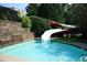 Resort-style community pool with a waterslide feature, perfect for Gathering fun at 6640 Stratford Pl, Cumming, GA 30040