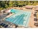 Large community pool with lounge chairs and umbrellas, ideal for relaxation and recreation at 6640 Stratford Pl, Cumming, GA 30040
