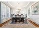 Elegant dining room featuring crown molding, chandelier, and large windows at 6640 Stratford Pl, Cumming, GA 30040
