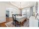 Dining room with hardwood floors, chandelier, and views to living spaces at 6640 Stratford Pl, Cumming, GA 30040