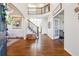 Grand foyer featuring hardwood floors, staircase, and open view to other rooms at 6640 Stratford Pl, Cumming, GA 30040